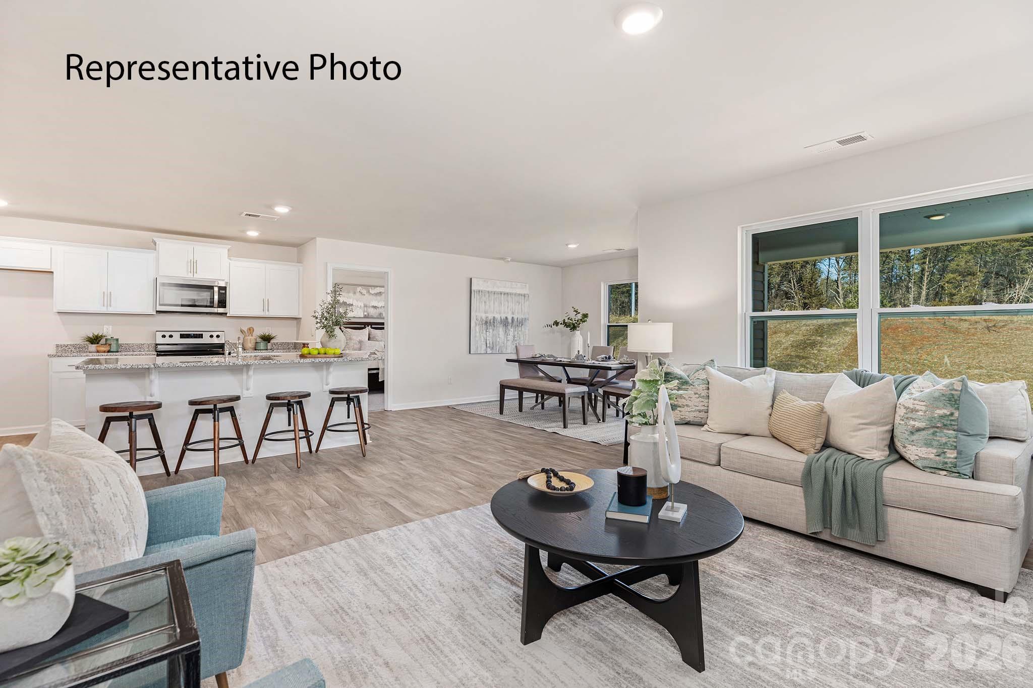 3647 Charles Street Northwest Conover, NC 28613 - Photo 4 of 21 a living room with furniture a dining table and kitchen view