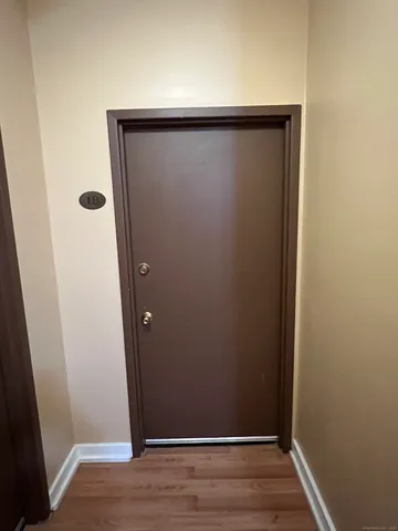 an empty room with wooden floor