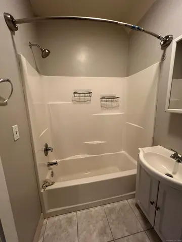 a bathroom with a bathtub and a sink