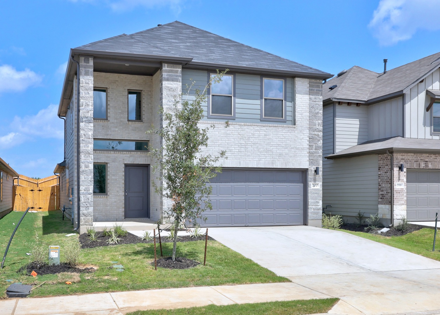 200 Hornet Street Elgin, TX 78621 - Photo 2 of 39 a front view of a house with a yard and garage