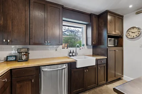 a kitchen with a sink cabinets and window