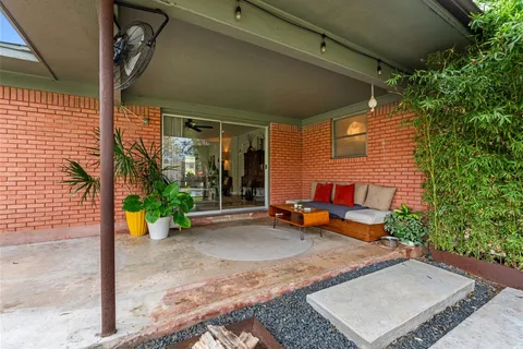 a backyard of a house with outdoor seating