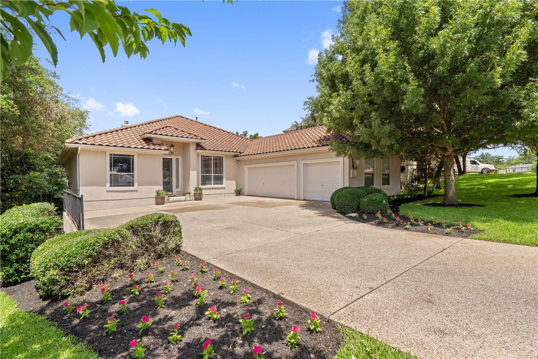 a front view of a house with a garden
