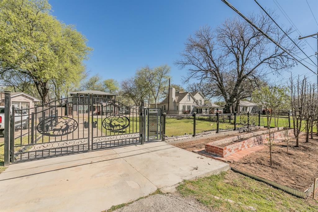 7612 Sommerville Place Road Fort Worth, TX 76135 - Photo 1 of 37 a view of a park with iron fence