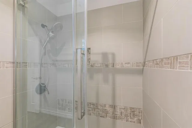 a bathroom with a granite countertop toilet a sink and a mirror