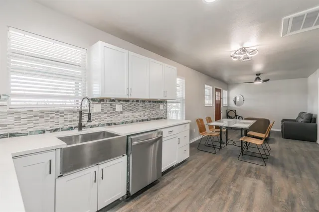 a work room with furniture wooden floor and a ceiling fan