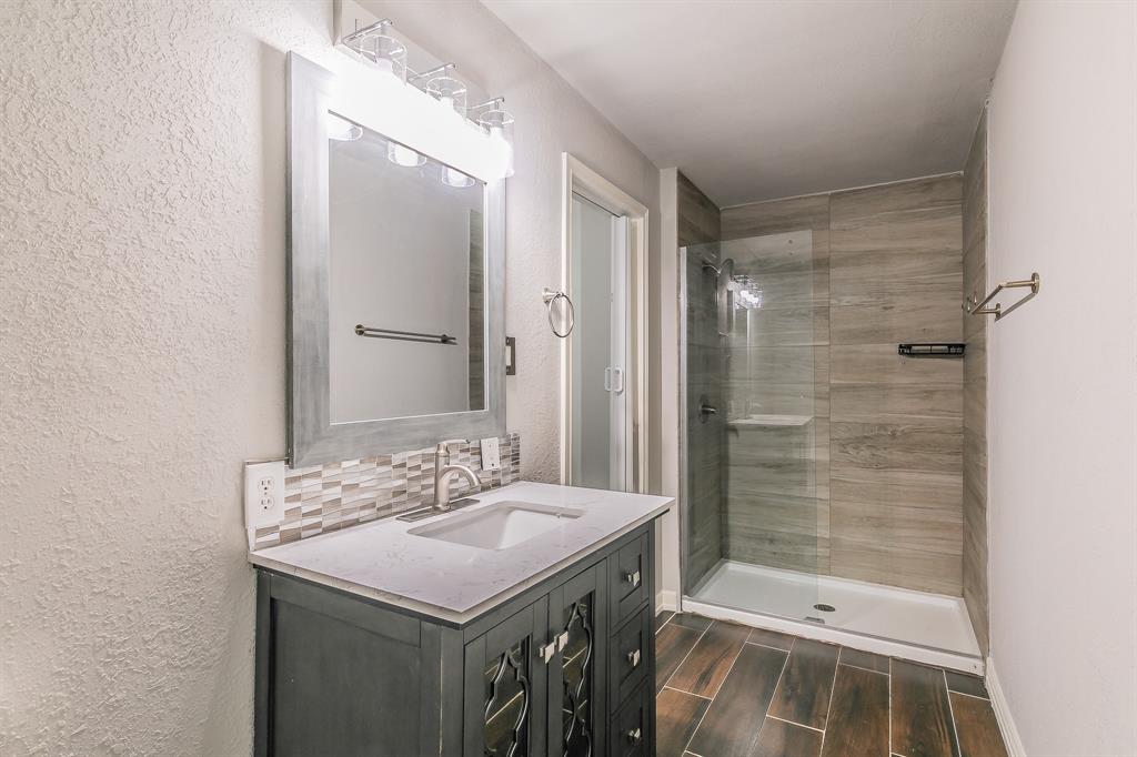 7612 Sommerville Place Road Fort Worth, TX 76135 - Photo 25 of 37 a bathroom with a sink a toilet and shower
