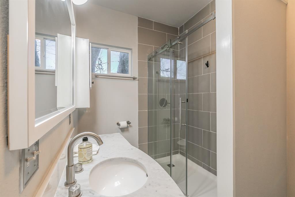 7612 Sommerville Place Road Fort Worth, TX 76135 - Photo 32 of 37 a bathroom with a sink and shower