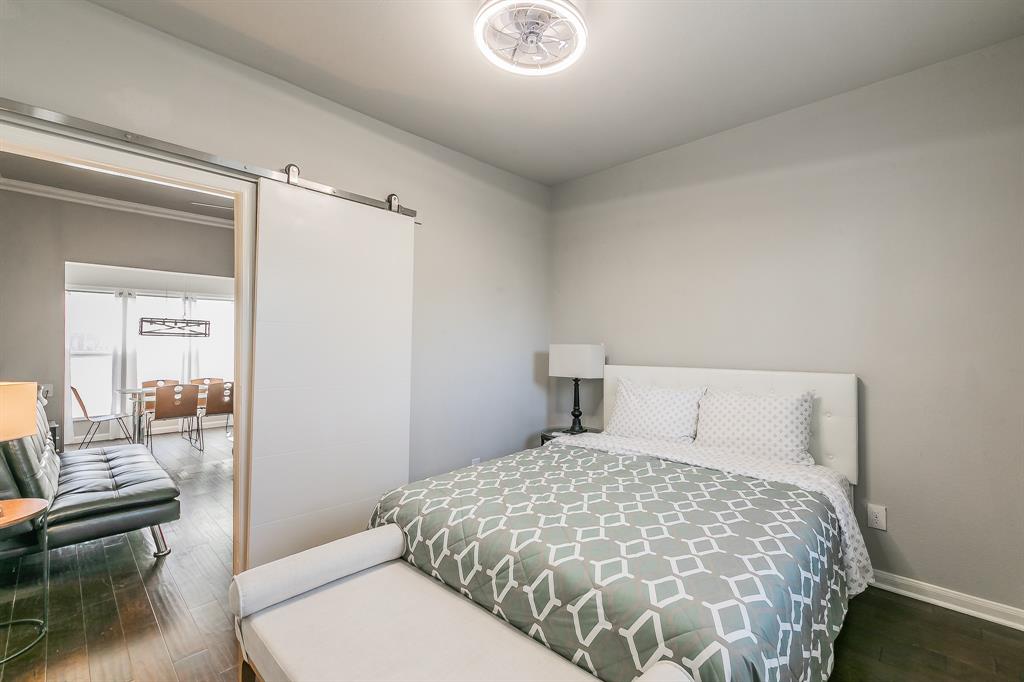 7612 Sommerville Place Road Fort Worth, TX 76135 - Photo 33 of 37 a bedroom with a large bed and a couch