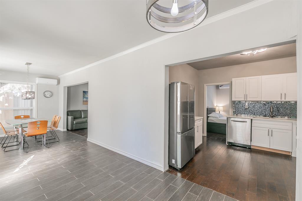 7612 Sommerville Place Road Fort Worth, TX 76135 - Photo 34 of 37 a kitchen with stainless steel appliances granite countertop a refrigerator and a stove top oven