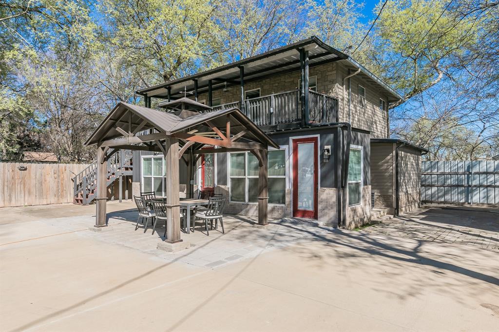 7612 Sommerville Place Road Fort Worth, TX 76135 - Photo 35 of 37 a patio with a table and chairs under an umbrella