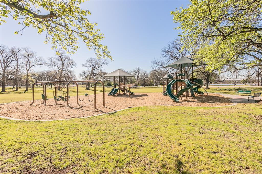 7612 Sommerville Place Road Fort Worth, TX 76135 - Photo 36 of 37 a view of a swimming pool with a bench and trees