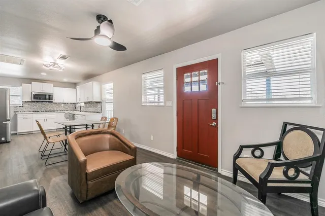 a view of a livingroom with wooden floor and a window