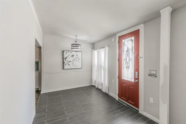 a living room with furniture and a view of kitchen