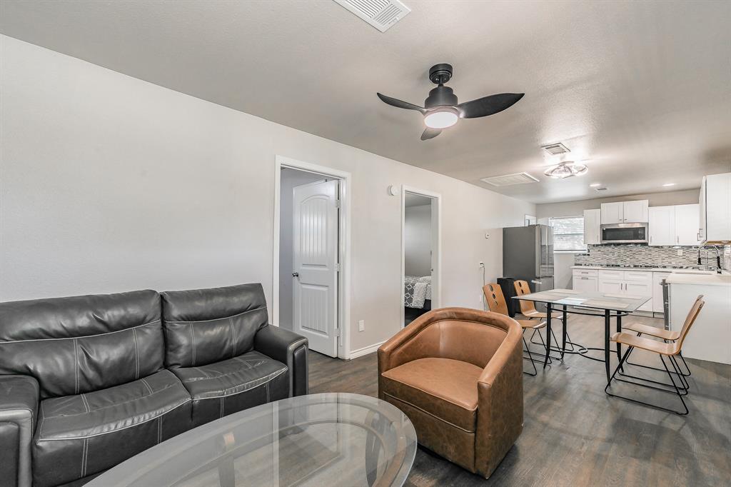 7612 Sommerville Place Road Fort Worth, TX 76135 - Photo 10 of 37 a living room with furniture and a view of kitchen
