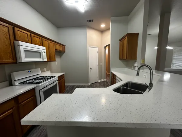 a kitchen with stainless steel appliances a sink stove and refrigerator