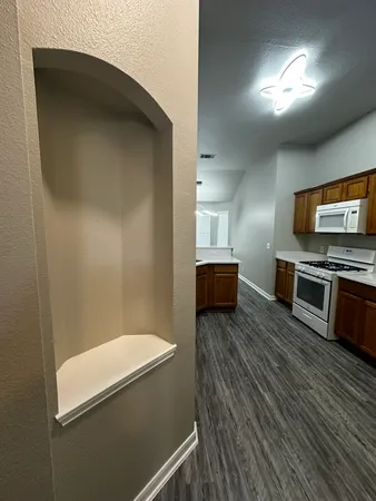 a view of a hallway with wooden floor and staircase