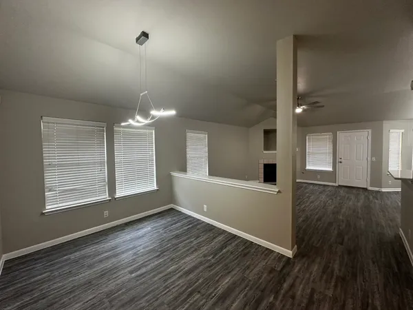 a view of empty room with wooden floor and fireplace