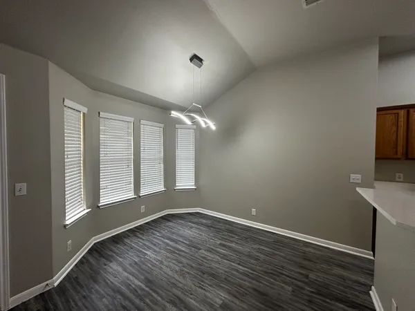 a kitchen with stainless steel appliances wooden floors and a stove