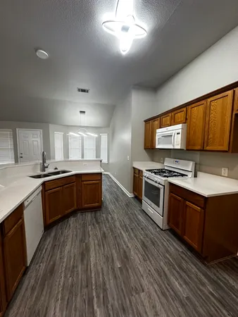 a kitchen with stainless steel appliances stove microwave and sink