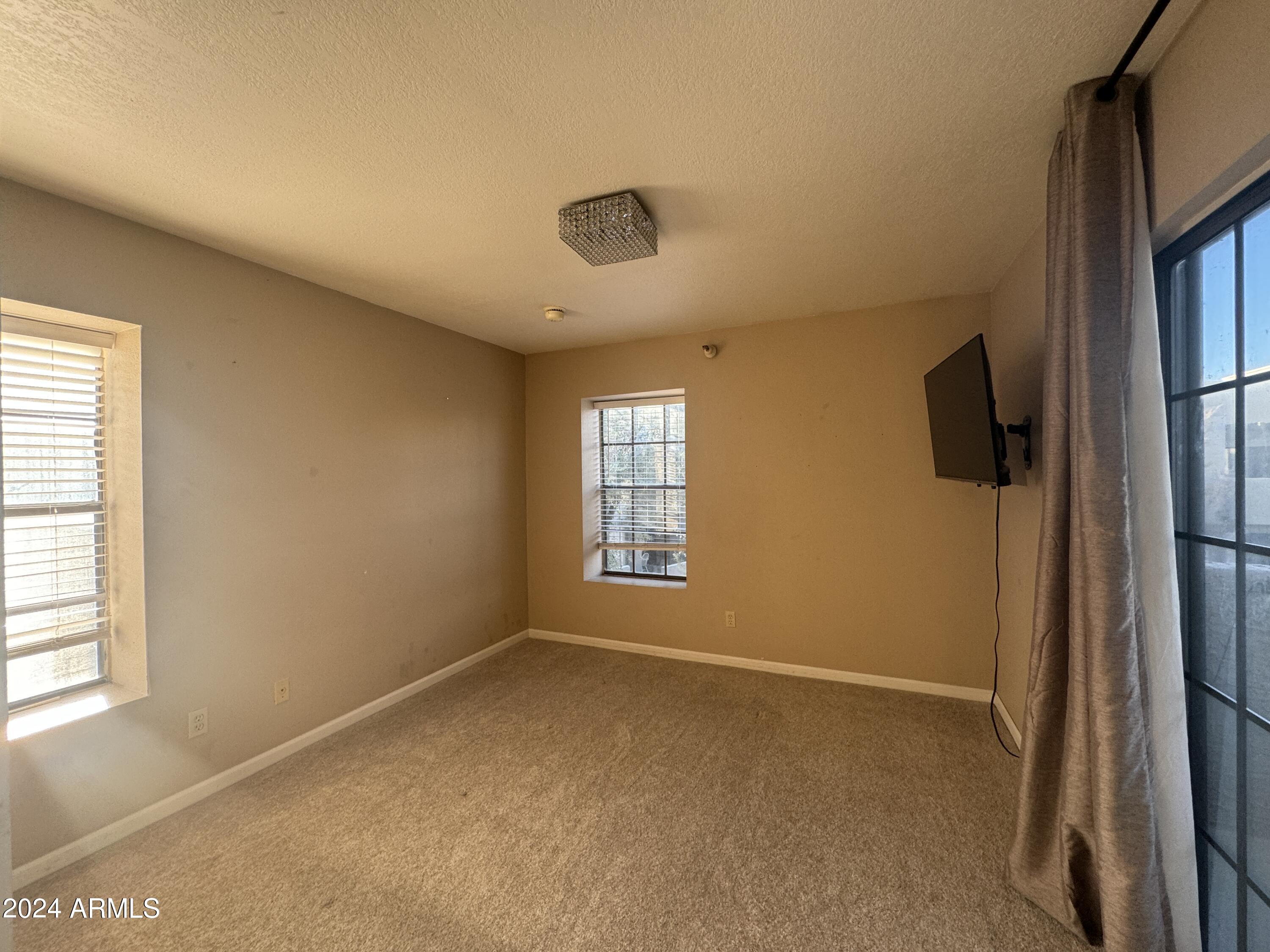 8020 East Thomas Road, Unit 226 Scottsdale, AZ 85251 - Photo 11 of 16 a view of an empty room with a window