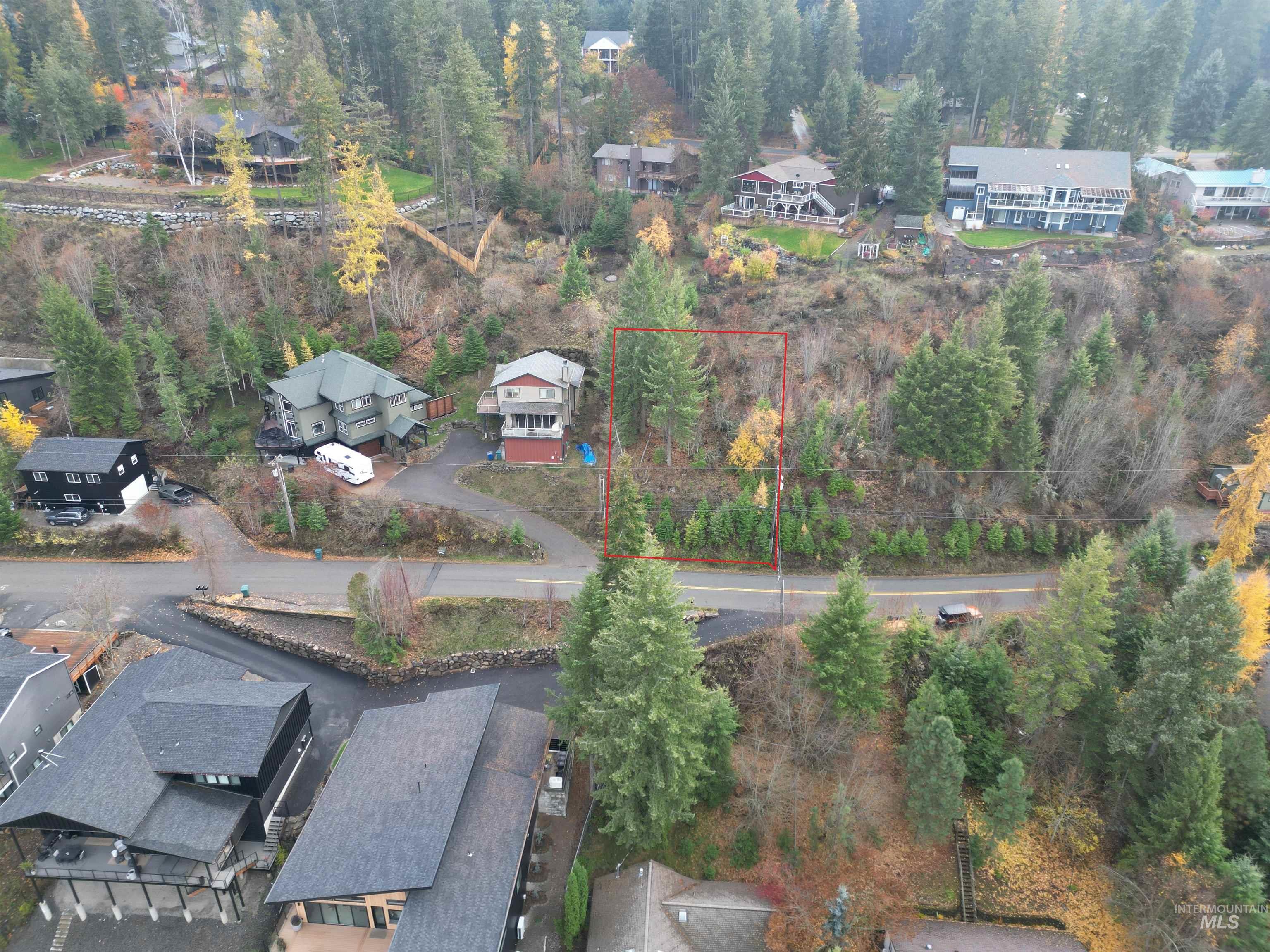 Nka East Upper Hayden Lake Road Hayden, ID 83835 - Photo 5 of 14 Aerial view of residential area with property boundaries highlighted and a heavily wooded area