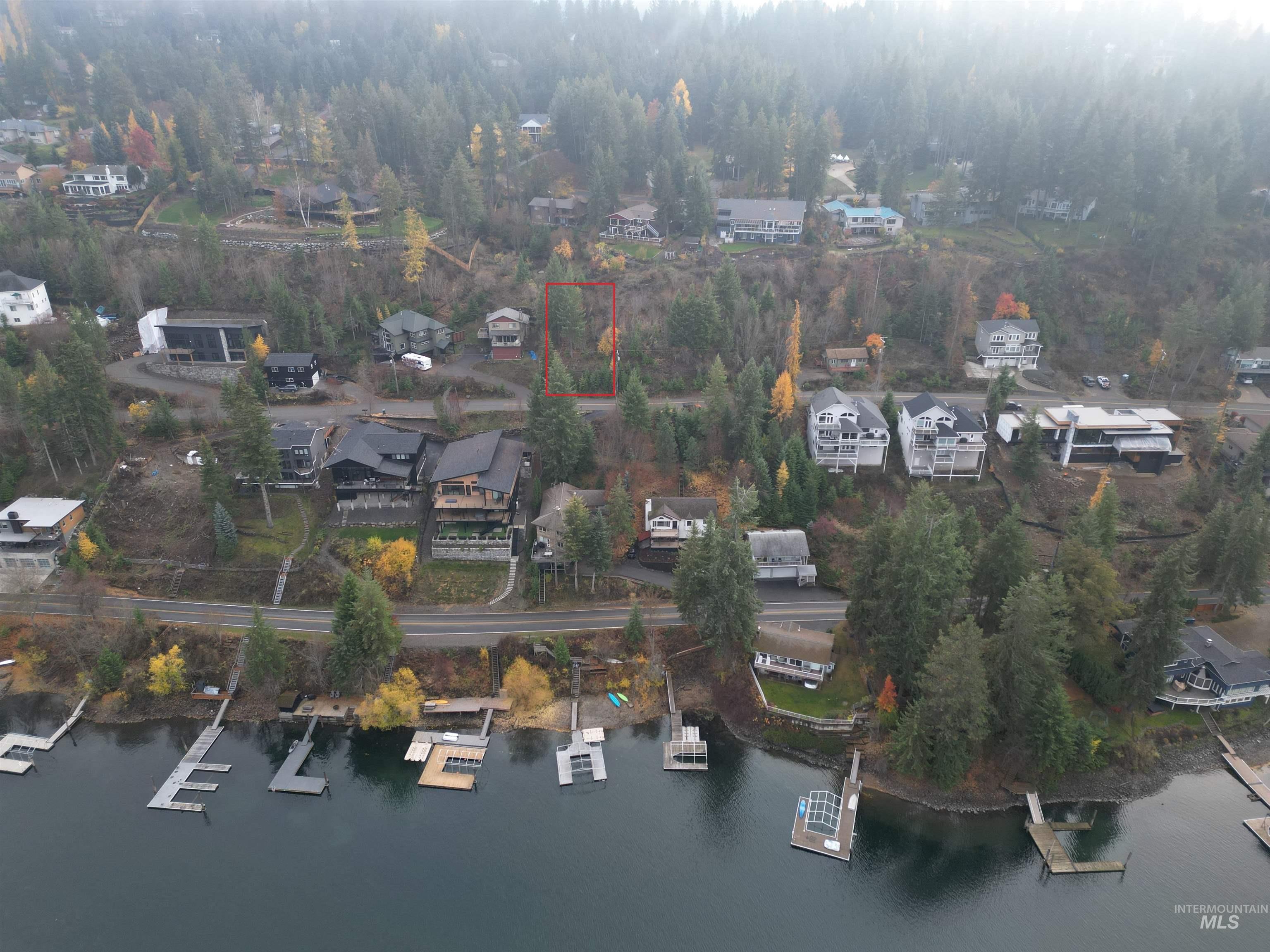 Nka East Upper Hayden Lake Road Hayden, ID 83835 - Photo 9 of 14 Aerial overview of property's location with nearby suburban area, property boundaries highlighted, and a large body of water