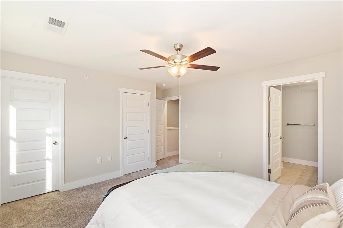 7000 Magnolia Crossings Spring Hill, TN 37174 - Photo 18 of 32 a bedroom with a large bed and a chandelier fan