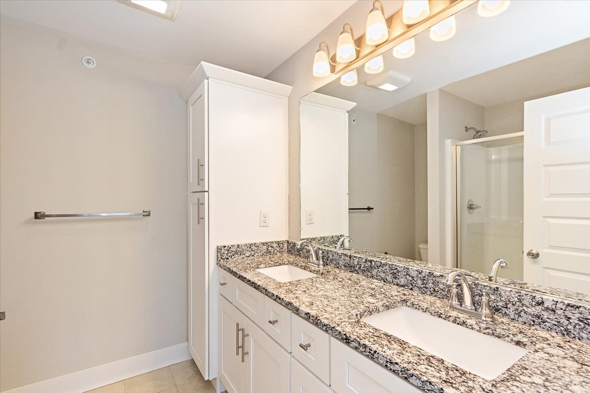 7000 Magnolia Crossings Spring Hill, TN 37174 - Photo 19 of 32 a bathroom with a granite countertop sink and a mirror