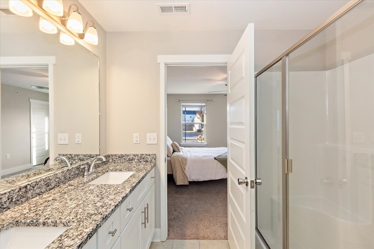 7000 Magnolia Crossings Spring Hill, TN 37174 - Photo 20 of 32 a en suite bathroom with a granite countertop sink and a mirror