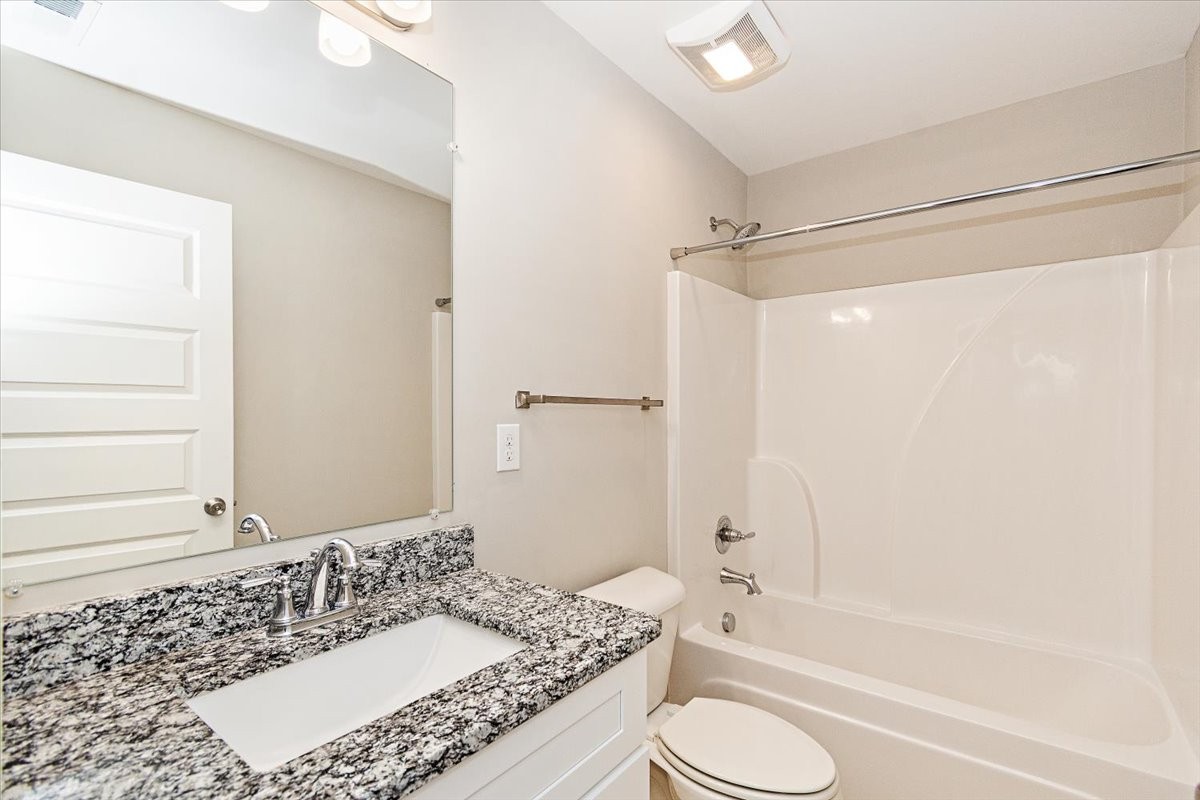 7000 Magnolia Crossings Spring Hill, TN 37174 - Photo 23 of 32 a bathroom with a granite countertop sink toilet and shower
