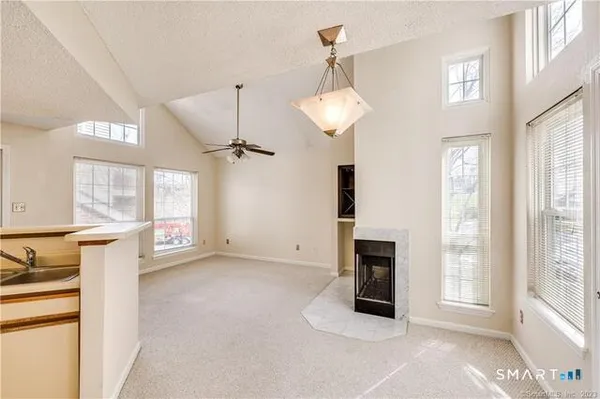 a view of a livingroom with an empty space and a fireplace