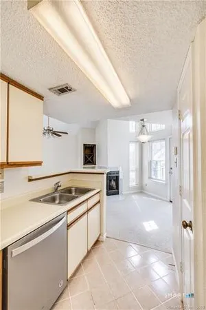 a kitchen with a stove a sink and a refrigerator