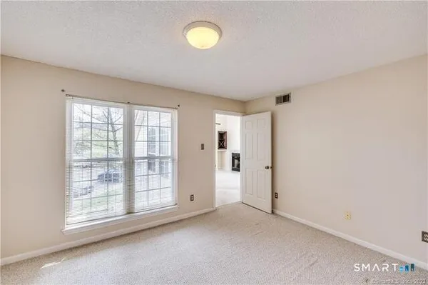 an empty room with windows and entrance