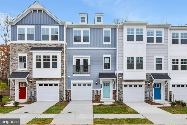 a front view of a building with a garden