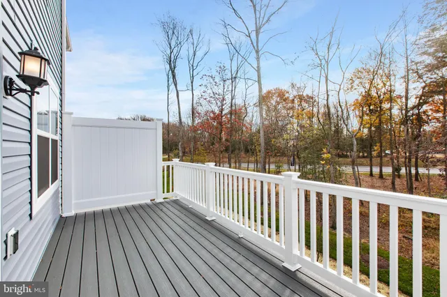 a view of a balcony with wooden floor and fence