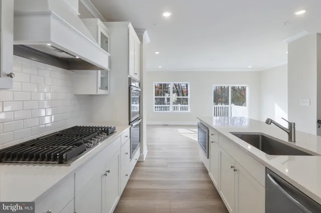 a kitchen with granite countertop a sink and cabinets