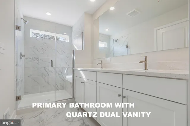 a bathroom with a sink a mirror and shower