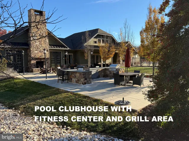 a large kitchen with stainless steel appliances granite countertop a refrigerator and a sink