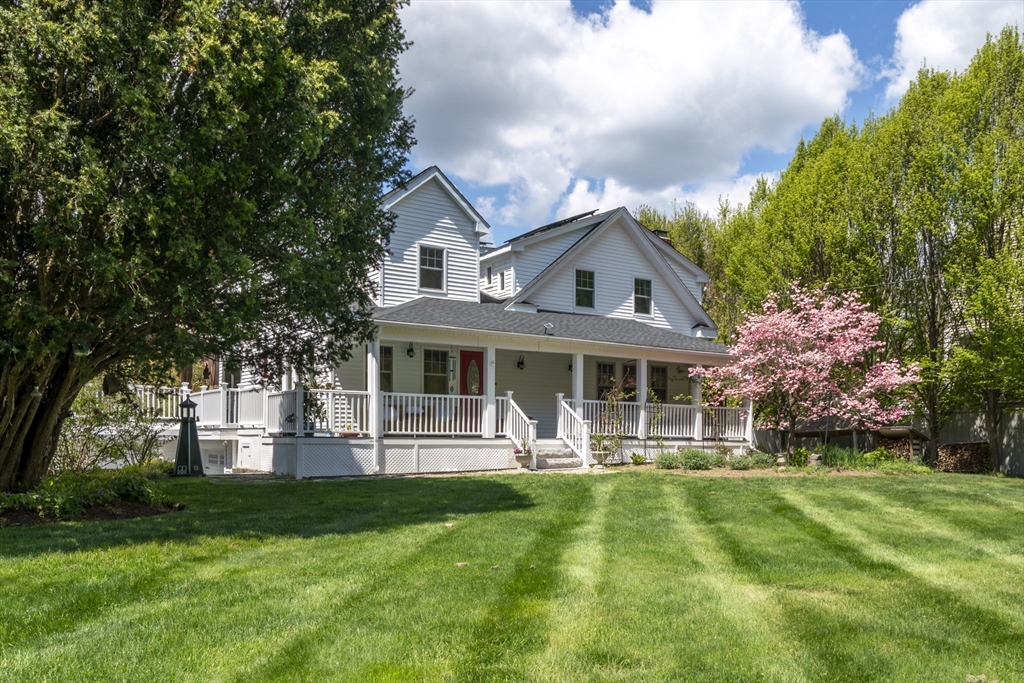 229 Parkerville Road Southborough, MA 01772 - Photo 2 of 38 a front view of a house with a yard table and chairs