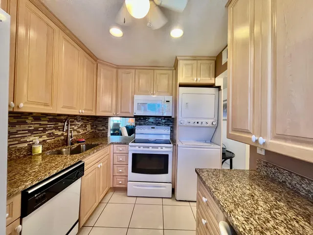 a kitchen with stainless steel appliances granite countertop a stove sink and cabinets