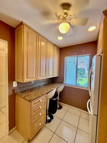 a kitchen with stainless steel appliances granite countertop a sink and a refrigerator