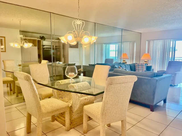 a dining room with furniture and chandelier