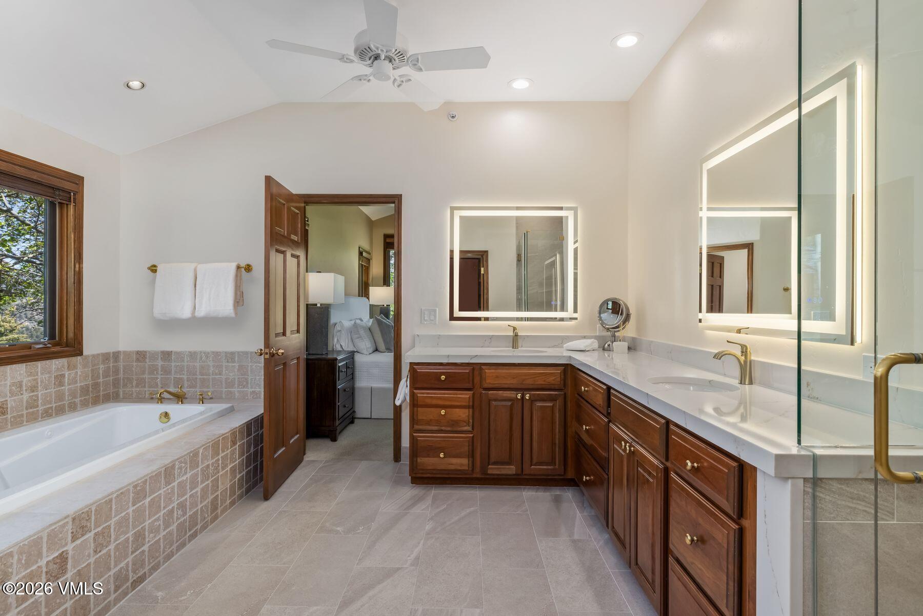 167 Saddle Ridge Edwards, CO 81632 - Photo 19 of 41 a spacious bathroom with a granite countertop tub double vanity sink a mirror and a shower