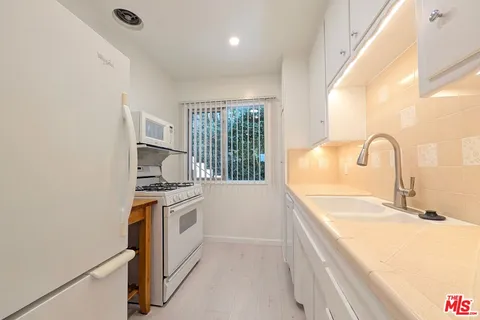 a kitchen with a stove and a refrigerator