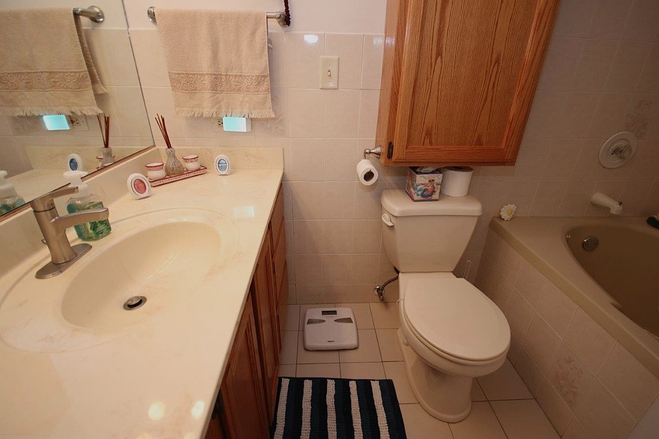 209 Gladys Avenue Fox River Grove, IL 60021 - Photo 15 of 23 a bathroom with a sink and a toilet