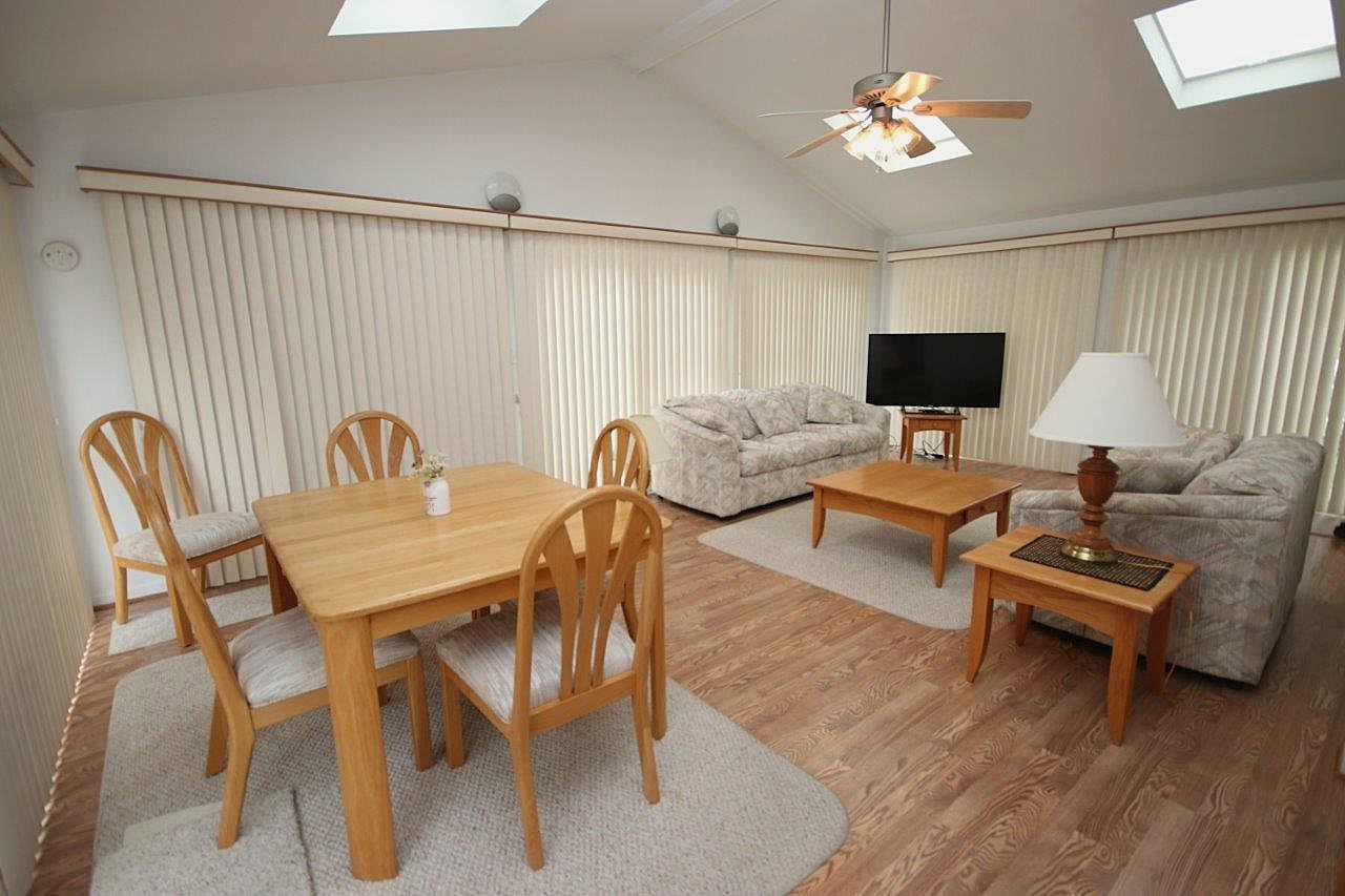 209 Gladys Avenue Fox River Grove, IL 60021 - Photo 3 of 23 a view of a livingroom and dining room with furniture wooden floor a chandelier