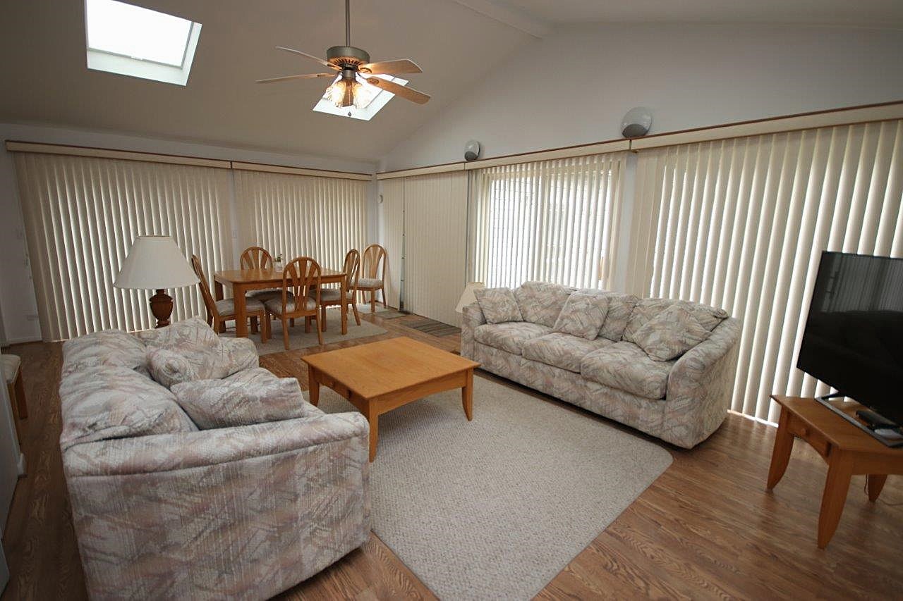 209 Gladys Avenue Fox River Grove, IL 60021 - Photo 4 of 23 a living room with furniture a ceiling fan and a window