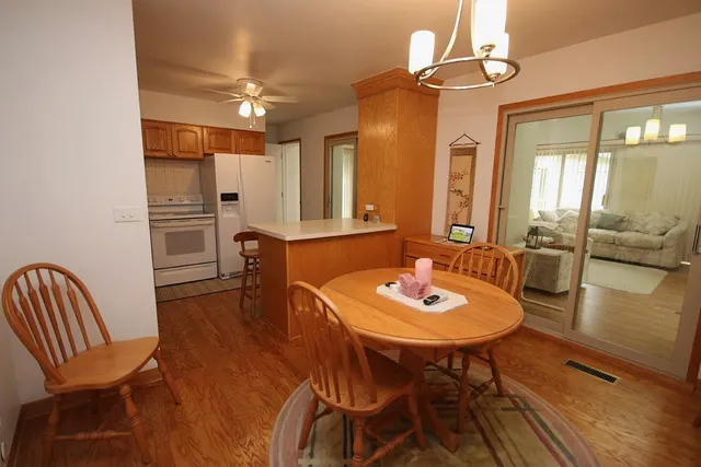 a view of a a dining room with furniture window and wooden floor