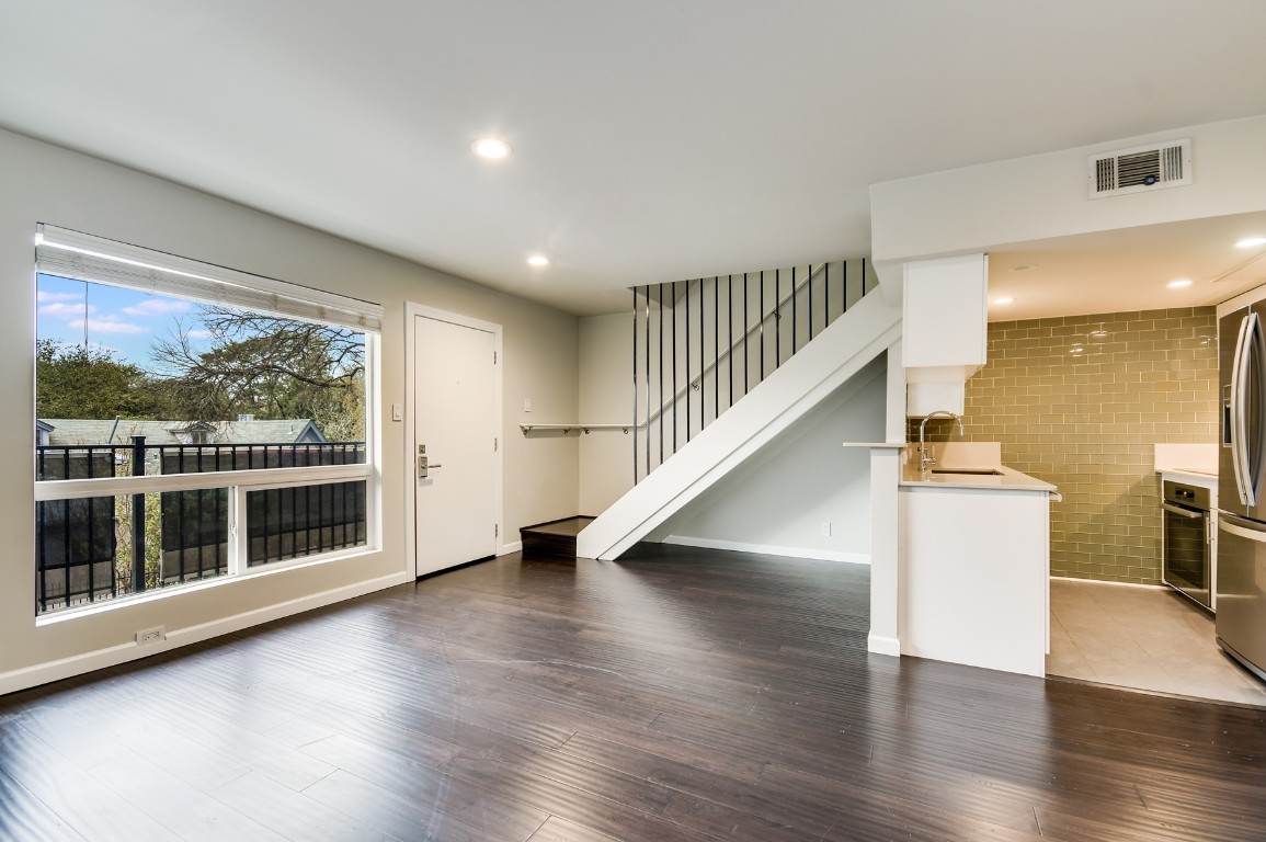 3110 Red River Street, Unit 221 Austin, TX 78705 - Photo 2 of 14 a view of entryway with wooden floor and stairs
